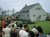 People Wait in Line Outside a New Levittown House