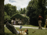 Tourist Copies Abraham Lincoln's Favored Position for Reading Outside