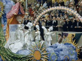 Masked and Costumed Queen and Attendants Ride on a Mardi Gras Float