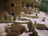 Tourists Explore Ruins of an Ancient Cliff Dwelling