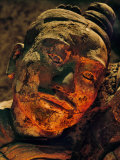 Warm Light Bathes Face of Terracotta Archer Emerging from Earth