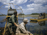 Men Ride Air Boats in Shallow Marshes