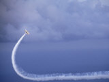 Biplane Makes a White Curved Pattern in the Sky