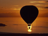 Riding in a Hot Air Balloon over Water at Sunset
