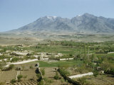 Green Fields Cover Valley Near Snow-Capped Mountains