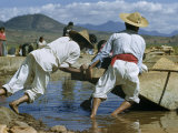 Fishermen Strain to Launch a Fishing Canoe