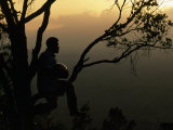 Man Sits in a Tree with a Large Gourd Used to Call Jaguars
