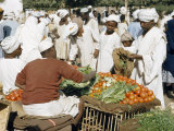 Customers Bargain with Vegetable Vendors at an Outdoor Market
