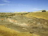 Black Car Sits on a Hill Overlooking Desolate Badlands