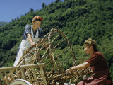 Farm Women Load Empty Baskets for Gathering Hay into Cart