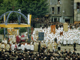 Penitents in White Robes and Worshipers Attend Open-Air Ceremony