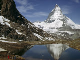 Tourists View the Matterhorn and its Reflection in Alpine Lake