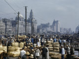 People and Bundles of Goods Crowd Waterfront Thoroughfare