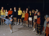 Young Ice Skater Executes a Spiral for a Smiling Audience