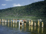 Girl Scouts and Counselors Stand in a Row Knee-Deep in a River
