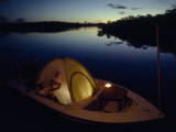 Man Fishing from a Tent on His Boat to Avoid Insects