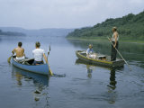 Canoeists Pass a Couple Poling a Rowboat Downriver with their Dog