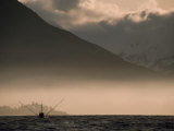 Fishing Boat Working in Moring Fog Off of a Mountainous Coast