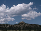 Puffy Clouds over Scenic Desert Hills and Distant Mountain