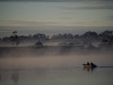 Local Fishermen Paddle a Rowboat Through the Early Morning Mist on the Clarence River