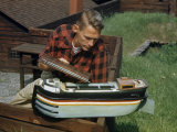 Tourist Inspects a Model of a Cargo-Carrying River Barge