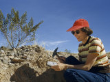 Woman Chips Rock Searching for Stones to Set in Jewelry