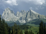 Jagged Mountain Peaks Tower over Green Alpine Valley
