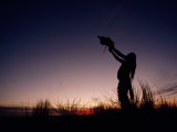 Native North American Holding an Artifact Up Towards the Sky