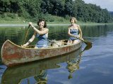 Women Demonstrate a Native American Style of Paddling a Canoe