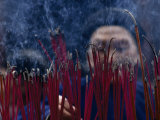 Chinese Man Lighting Incense at a Buddhist Temple