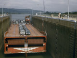 Four-Decker Barge Carrying New Cars Enters a Dam's Lock