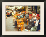 Lebanese Gentlemen sits at a steetside cafe sipping tea and smoking traditional narghile pipes