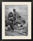 Boys Playing Cards on Steps in Town