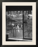 Suburban Housewife Hanging Out a Bit of Laundry  Seen Through Window in typical California Home