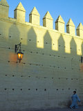 Woman Walks under the Ancient City Walls of Fez  Morocco