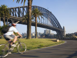 An Early Morning Cyclist Rounds Daves Point Reserve at Foot of Harbour Bridge  Sydney  Australia