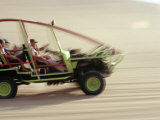 Dune Buggy Speeds Tourists Acoss Through the Sand Dunes Near Huacachina  in Southern Peru
