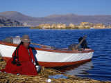Indian Woman from the Uros or Floating Reed Islands of Lake Titicaca  Washes Her Pans in the Water 