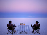Tourists Enjoy Sundowners While Looking Out across the Endless Salt Crust of Salar De Uyuni
