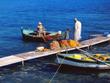 Fisherman and His Wife Cleaning the Fishing Nets in Boat and Jetty  Corfu  Greek Islands  Greece