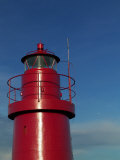 A Red Lighthouse with Blue Sky