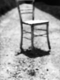 Empty Straight-Backed Chair in Spotlight