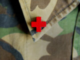 Red Cross on the Collar of a Camouflage Jacket