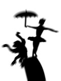 Silhouette of Ballerina Holding Umbrella with Performing Monkey