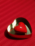 Heart Shaped Box Containing a Love Stone with Strong Red Background