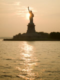 Sun Setting Behind the Statue of Liberty on a Summer Evening