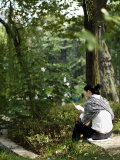 Young Woman Reading by a Lily Pond in the Jing'An Park