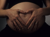 Nine Month Pregnant Woman Holds Her Large Belly