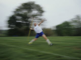 Young Man Tossing a Javelin During a High School Track Meet