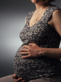 Nine Month Pregnant Woman Holds Her Belly